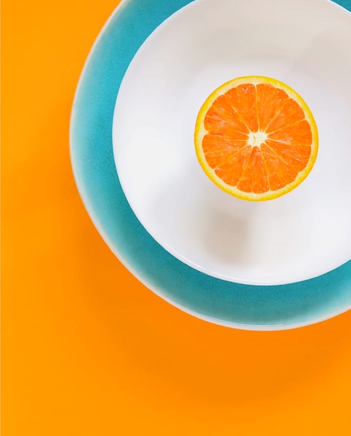 Half orange in a plate