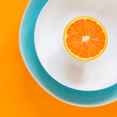 Half orange in a plate